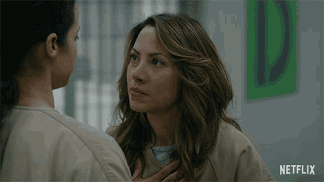 two women are looking at each other with a netflix logo behind them