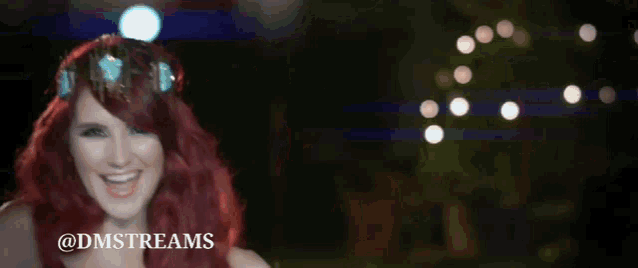 a woman with red hair is wearing a crown and smiling with the words @dmstreams above her