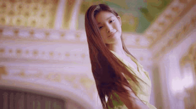 a woman with long hair is standing in a room
