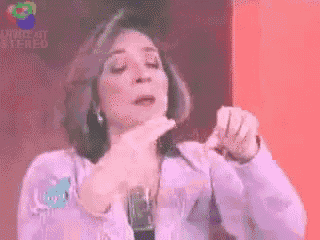 a woman is making a funny face in front of a sign that says ' void of stereo '