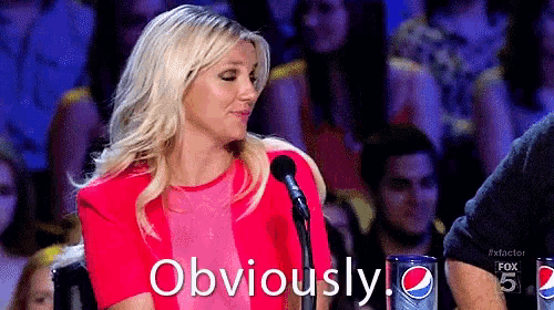 a woman in a red dress is sitting in front of a microphone and says obviously