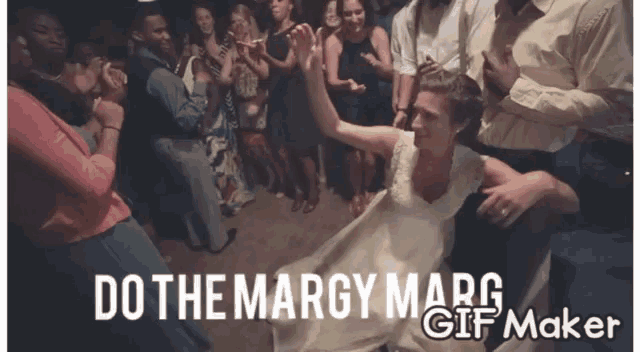 a woman in a white dress is dancing in front of a crowd with the words do the margy marg gif maker below her
