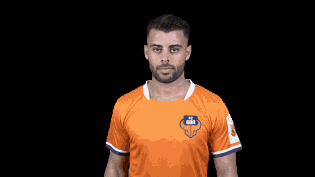 a man wearing an orange shirt with fc gor on it