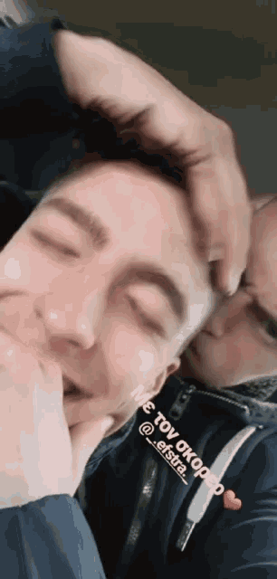a man putting his hand on another man 's head with a heart in the upper right corner