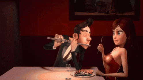 a man and a woman are sitting at a table with a plate of food in front of them