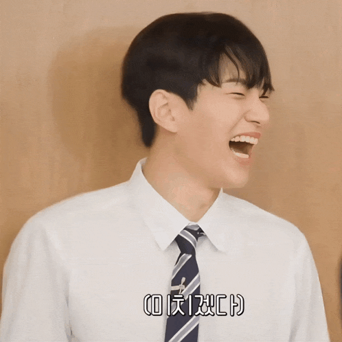 a man in a white shirt and tie is laughing with chinese writing on his shirt