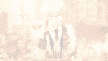 a man in a suit and tie is writing on a piece of paper in front of a flower vase
