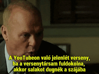a man in a suit and tie is speaking in a foreign language