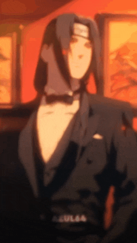 a man in a tuxedo with a bow tie is standing in a room .