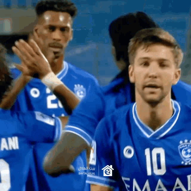 a group of soccer players wearing blue jerseys with the number 10 on the front