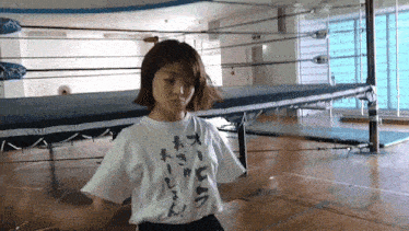 a woman wearing a white t-shirt with japanese writing on it
