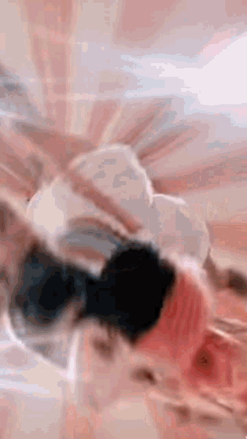 a group of people are laying on top of each other on a bed in a room .