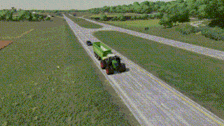 a green tractor is plowing a field with a blue plow attached to it