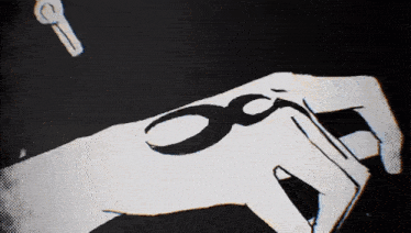 a black and white drawing of a hand holding a pair of scissors and a key