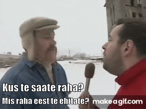 a man is holding a microphone and talking to another man .