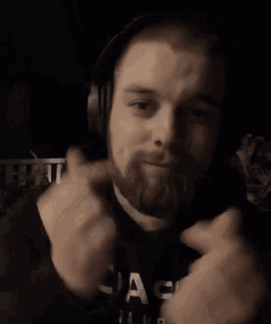 a man with a beard wearing headphones and a shirt that says " a9 " on it