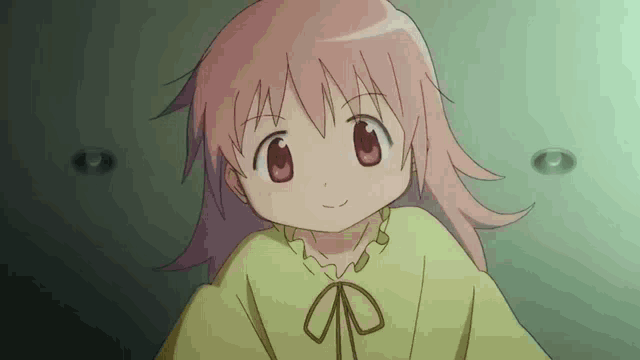 a little girl with pink hair and red eyes is wearing a yellow shirt and smiling .