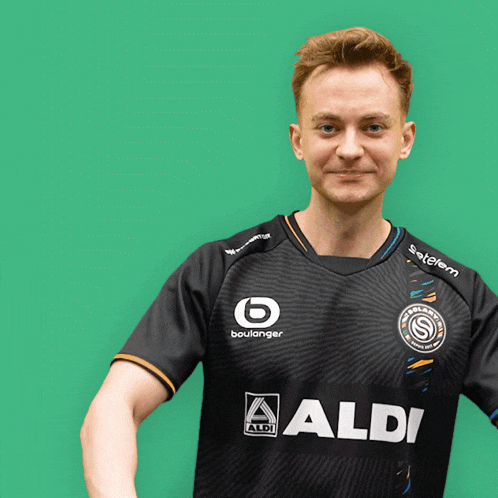 a man wearing a black shirt that says aldi on the front