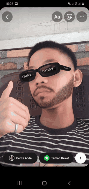 a man with a beard wearing sunglasses with the word ayang on them