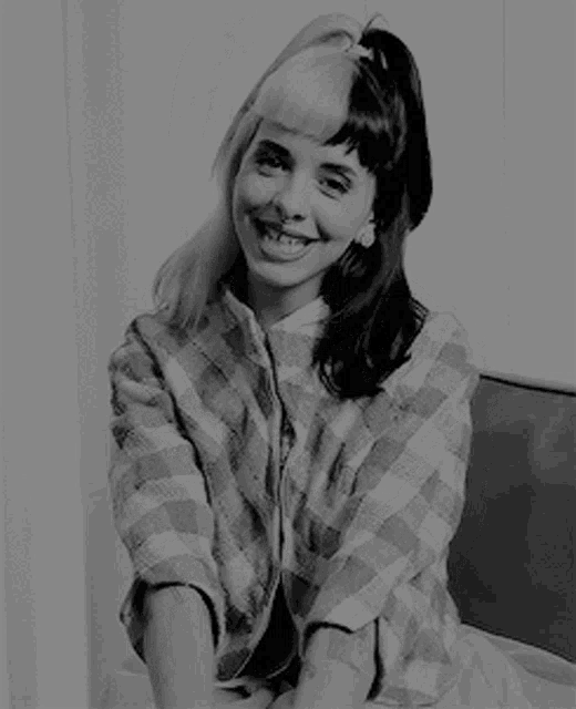 a black and white photo of a woman with half black and half white hair