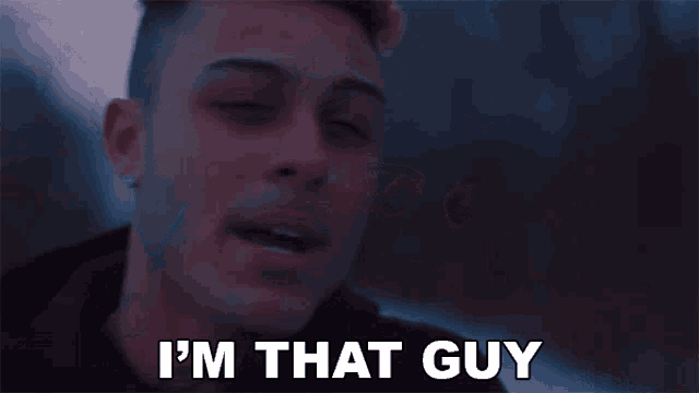 a young man is saying `` i 'm that guy '' while looking at the camera .
