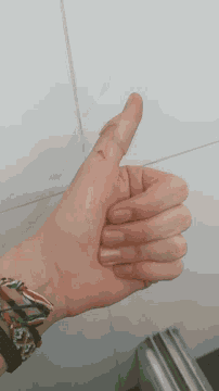 a close up of a person 's hand with a wristband that says ' a ' on it