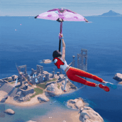 a woman in red pants is flying through the air holding a pink parachute