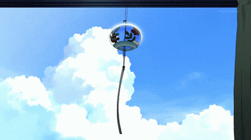 a wind chime hanging from a window with tokyo mx on the bottom right corner