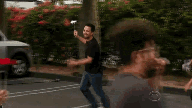 two men are holding flowers in their hands in a parking lot