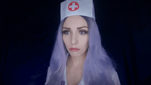 a woman with purple hair and a nurse hat with a red cross on it