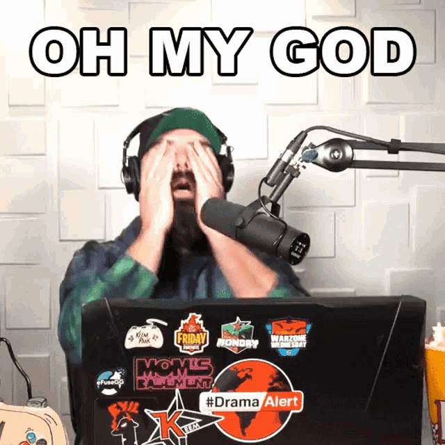 a man covering his eyes in front of a microphone with the words oh my god written above him