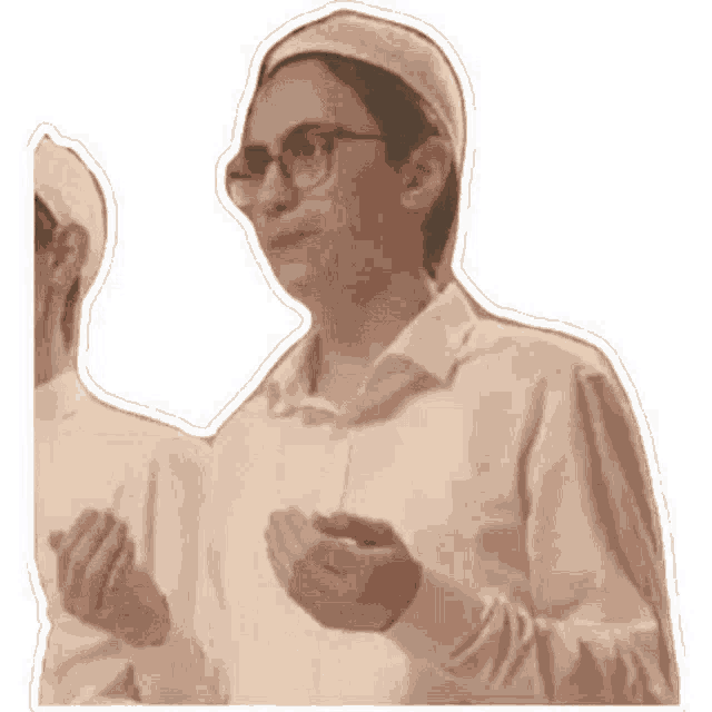 a man with glasses and a hat is praying