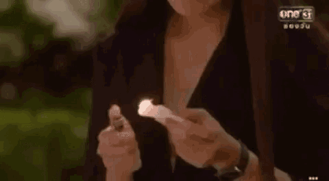 a woman is crying while holding a piece of paper in her hands .