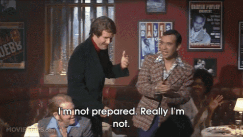 a group of men are standing in a room and one of them says " i 'm not prepared "