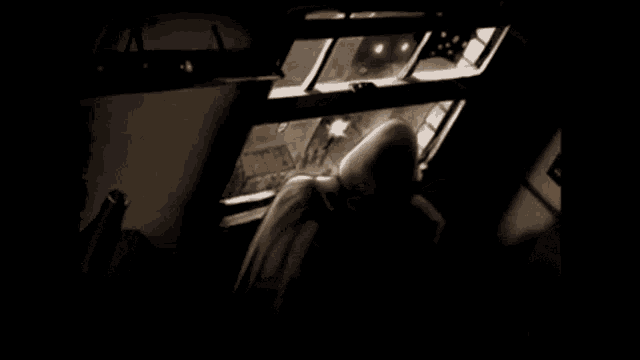 a black and white photo of a person in a dark room