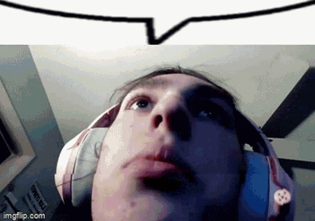 a close up of a person 's face with headphones on .