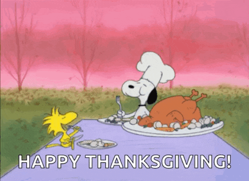snoopy and woodstock are sitting at a table with a plate of food and a turkey .
