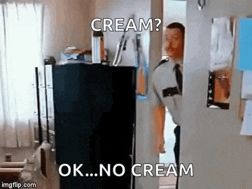 a man in a police uniform is standing in front of a black refrigerator .