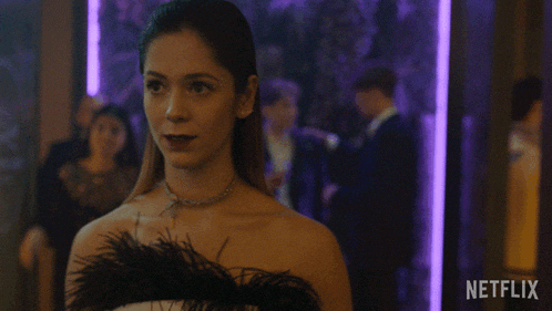 a woman in a feathered dress says hola in a netflix ad