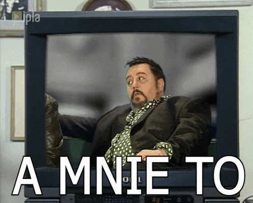 a man in a suit and tie is sitting in front of a television with the words a mnie to on it