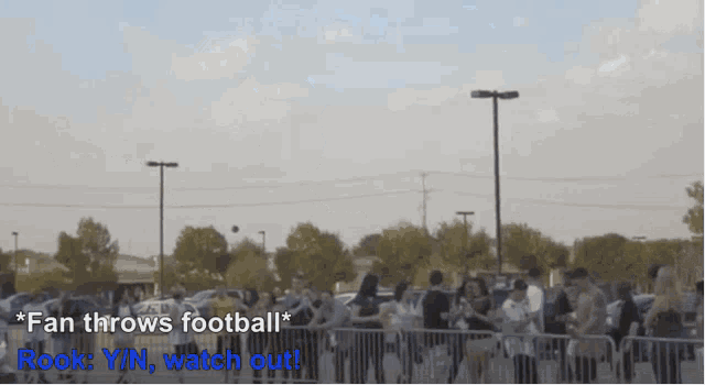 a football is being thrown in the air with the words fan throws football rook y / n watch out