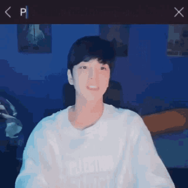 a young man wearing a white sweatshirt with the name putang on it