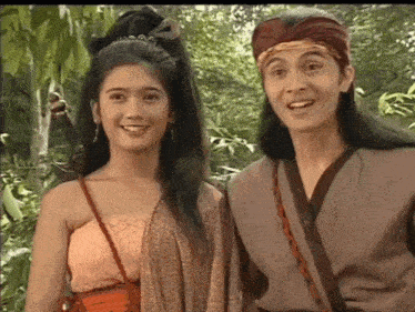 a man and a woman are standing next to each other and smiling .