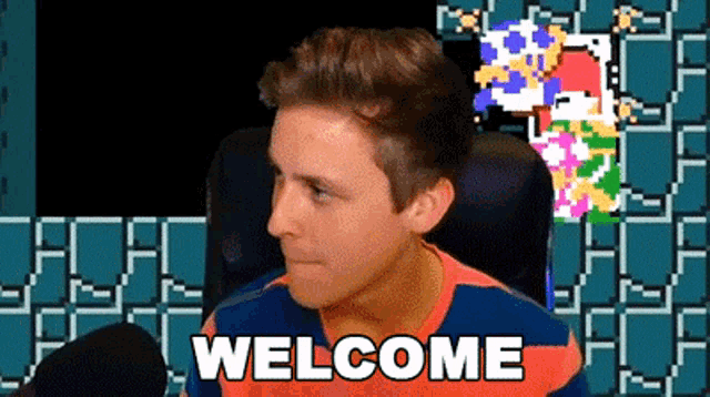 a man is sitting in front of a video game and says welcome