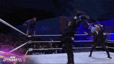 a wrestling match is being shown on a screen that says new dynamite