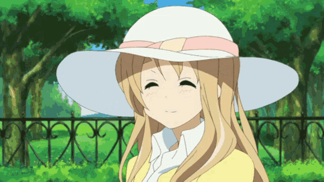 a girl wearing a white hat with a pink bow is smiling