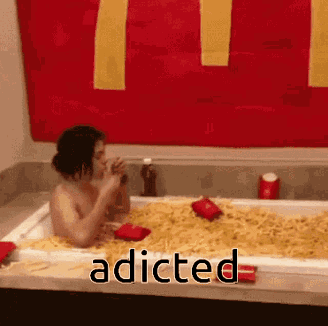 a woman is taking a bath in a tub filled with french fries and drinking a soda