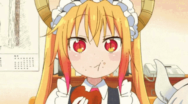 a girl with horns is eating a piece of food with her mouth .