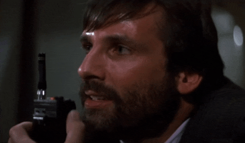 a man with a beard is holding a lighter in his hand