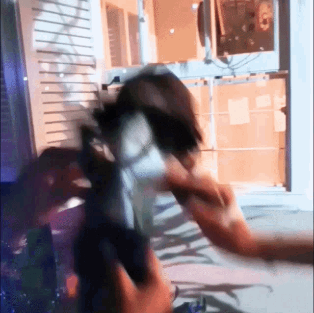 a blurry picture of a person 's face with a reflection of a person 's face on the wall